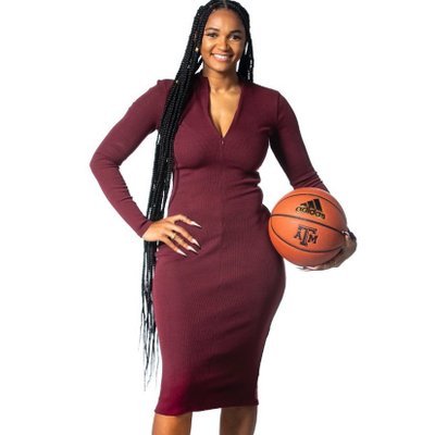 Woman in a maroon dress holding a basketball.